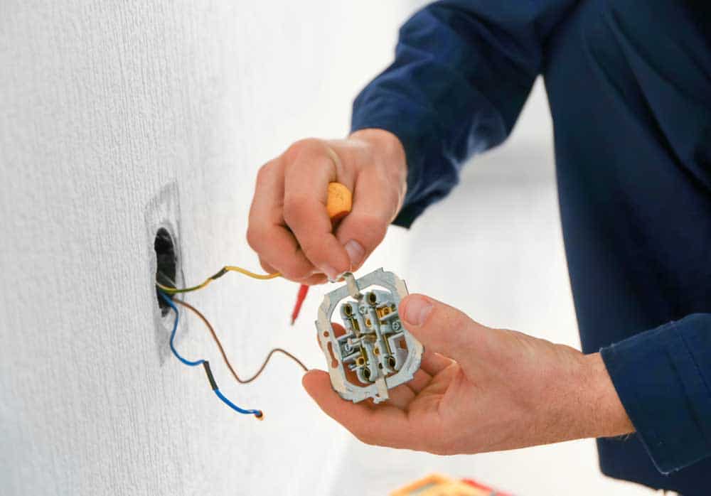 An Electrician Wiring In A Home In Canberra