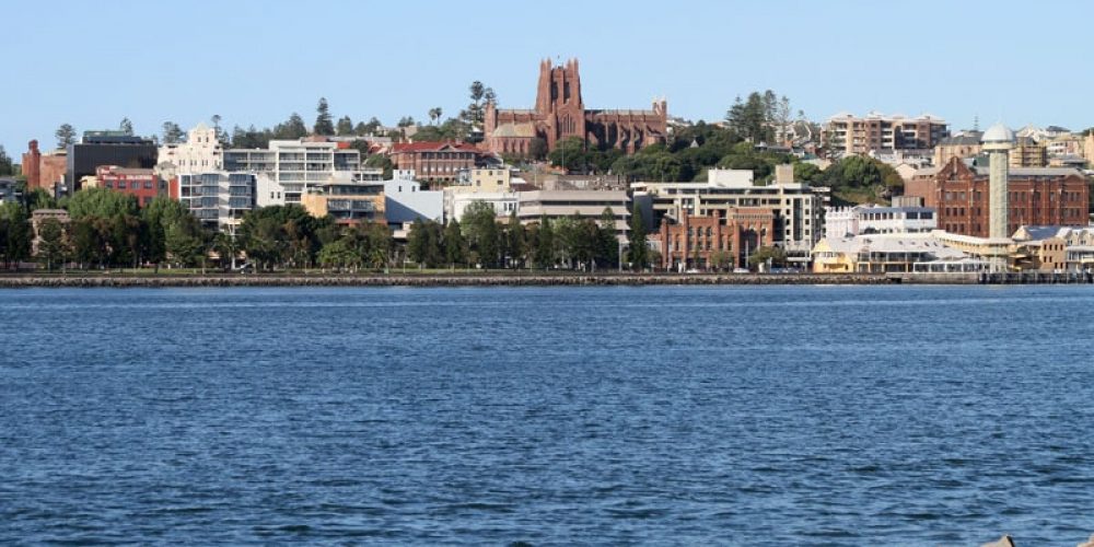 Looking Across The Hunter River From Griffith Park, Stockton To Newcastle With The Wharves In The Foreground And Christ Church Anglican Cathedral On The Skyline.
